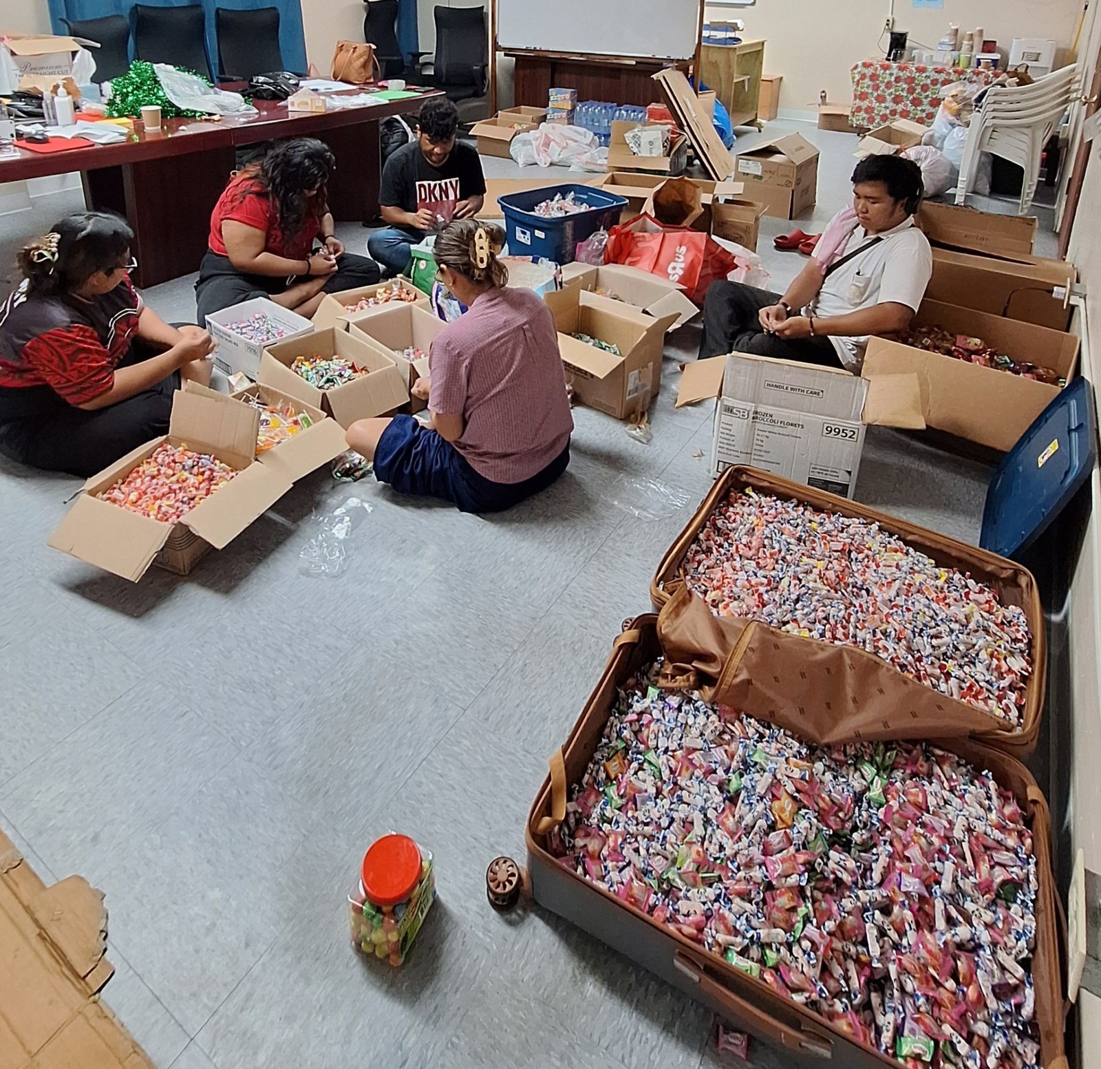 A group sorting sweets into boxes for a celebration